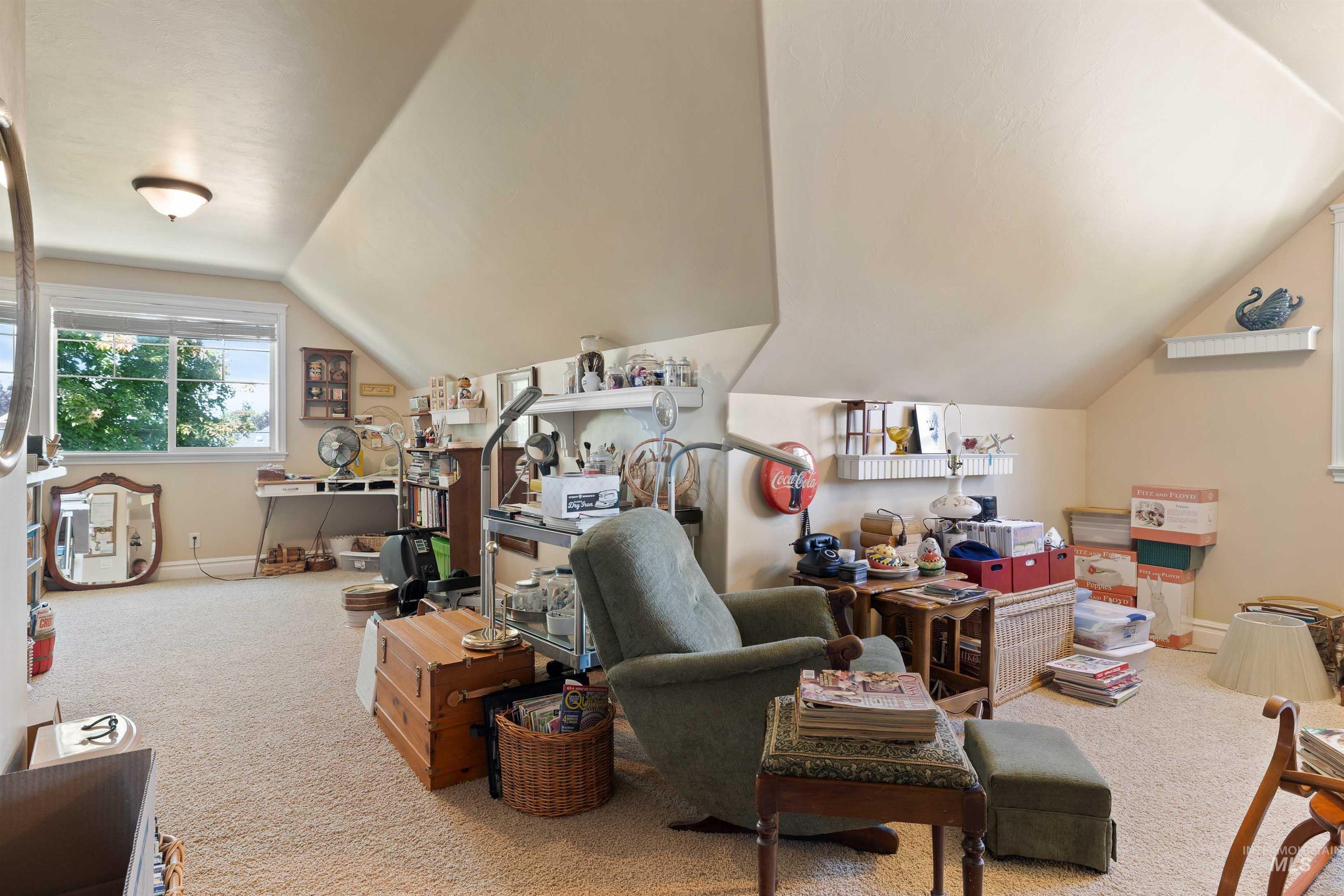 Carpeted bonus room/4th bedroom featuring lofted ceiling and a 1/2 bath