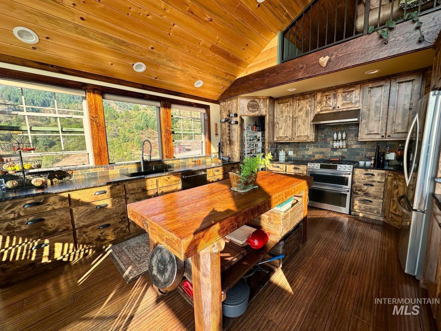 Kitchen featuring wooden ceiling, lofted ceiling, stainless steel appliances, dark wood-style floors, and decorative backsplash