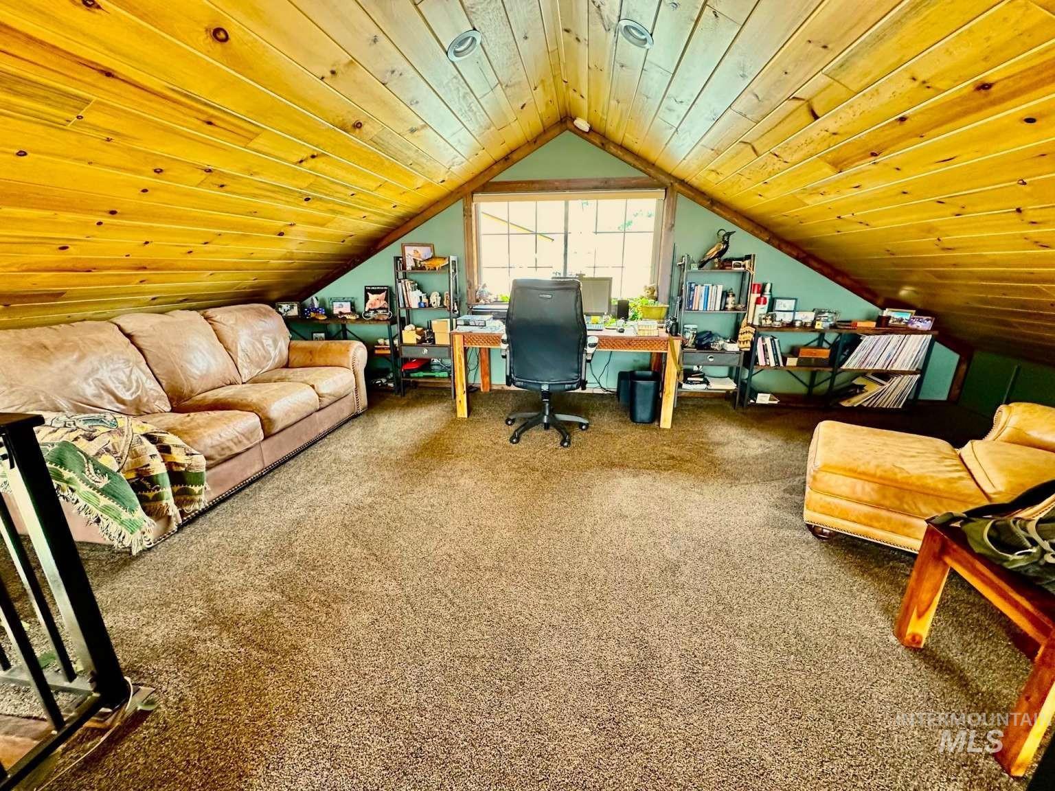 Office area featuring wood ceiling, carpet flooring, and lofted ceiling
