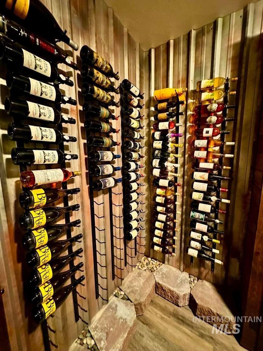 Wine room featuring electric panel and wood walls