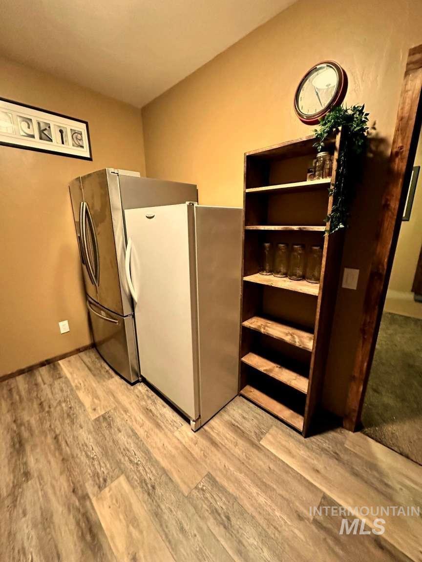 Kitchen featuring freestanding refrigerator and light wood-style flooring