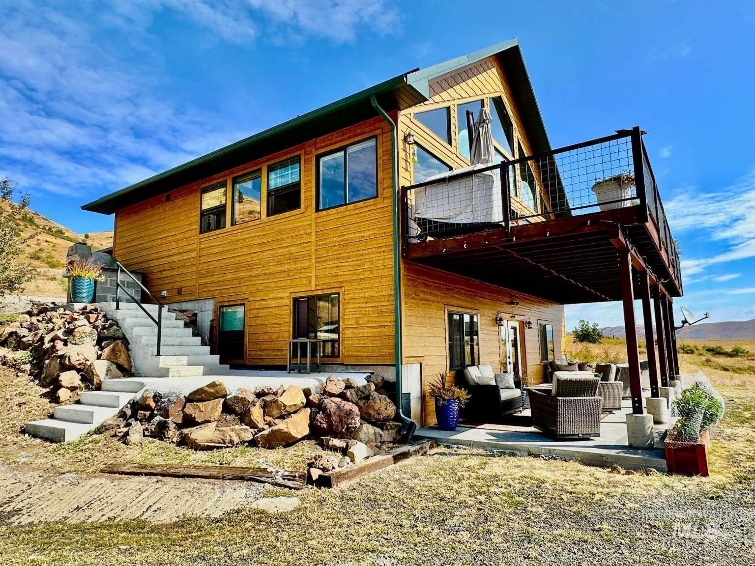 Rear view of house with a patio area, stairway, an outdoor living space, and a wooden deck