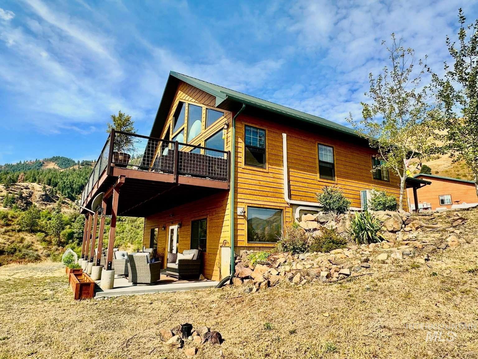 Rear view of property featuring a patio area, an outdoor hangout area, and a wooden deck