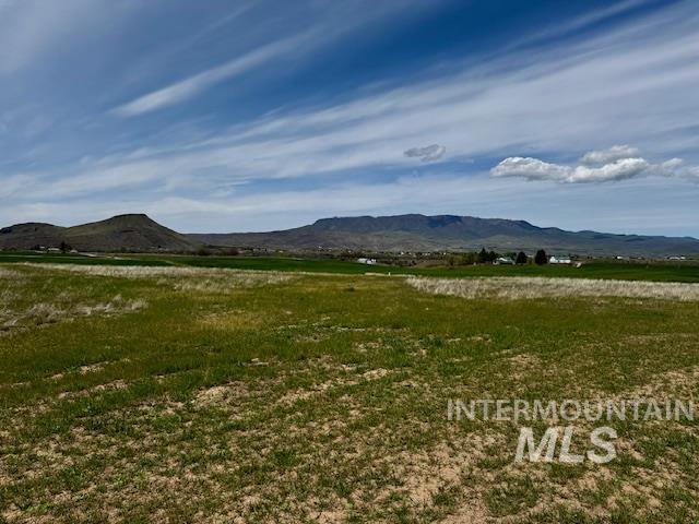 View of mountain backdrop with rural landscape