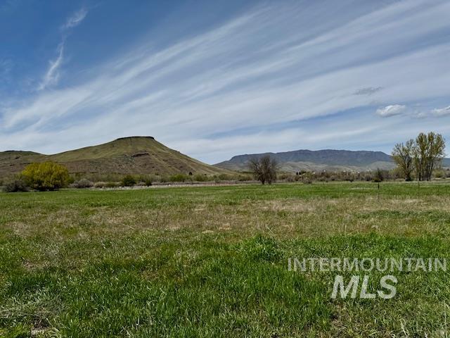 View of mountain backdrop featuring rural landscape