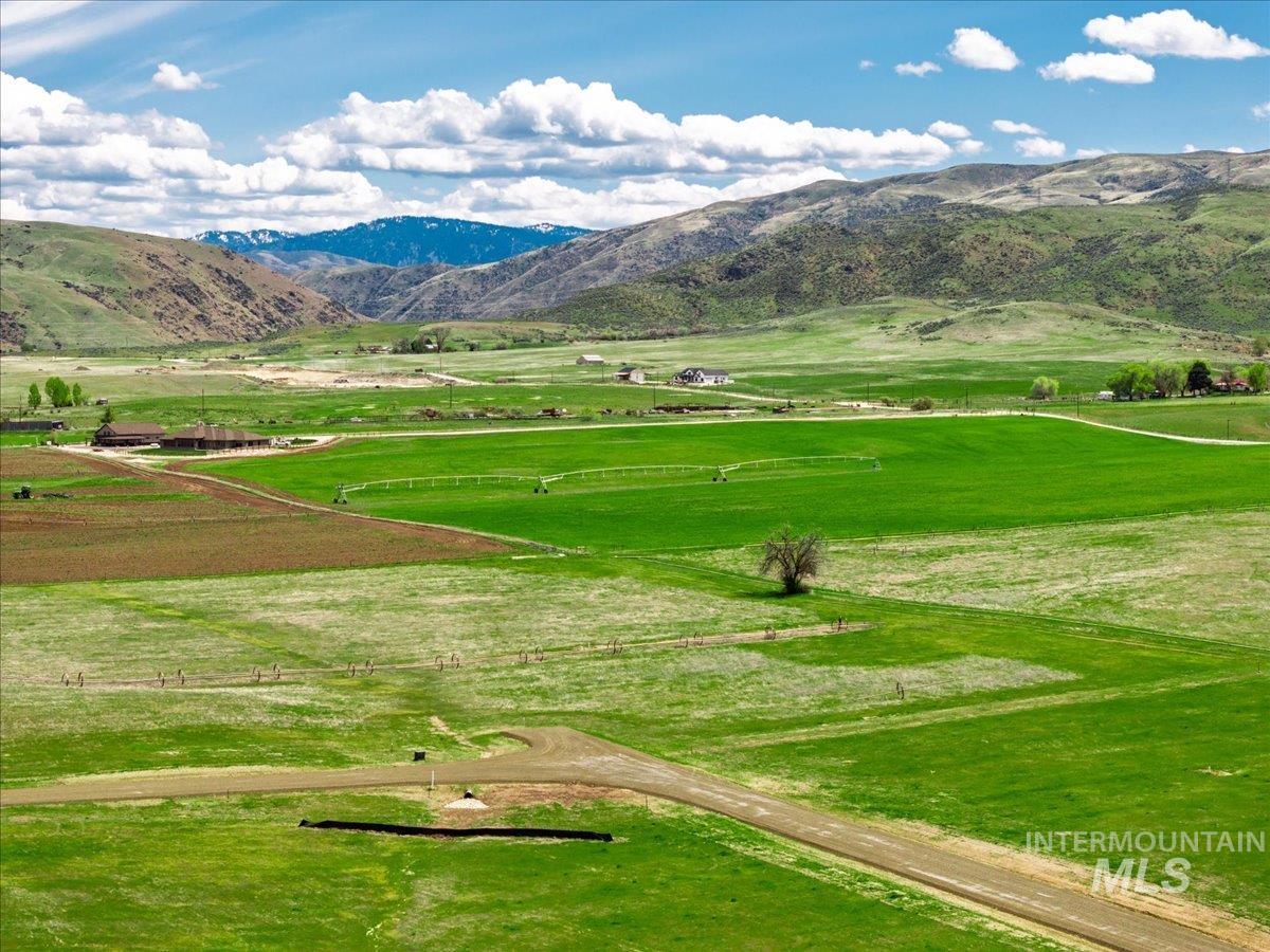 View of community with a rural view, a mountain view, and agricultural plots