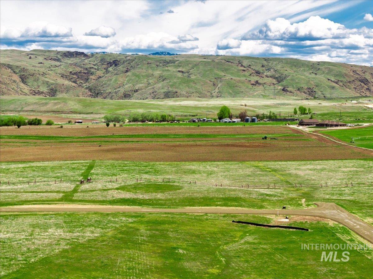Surrounding community featuring a view of countryside, a mountain view, and agricultural area