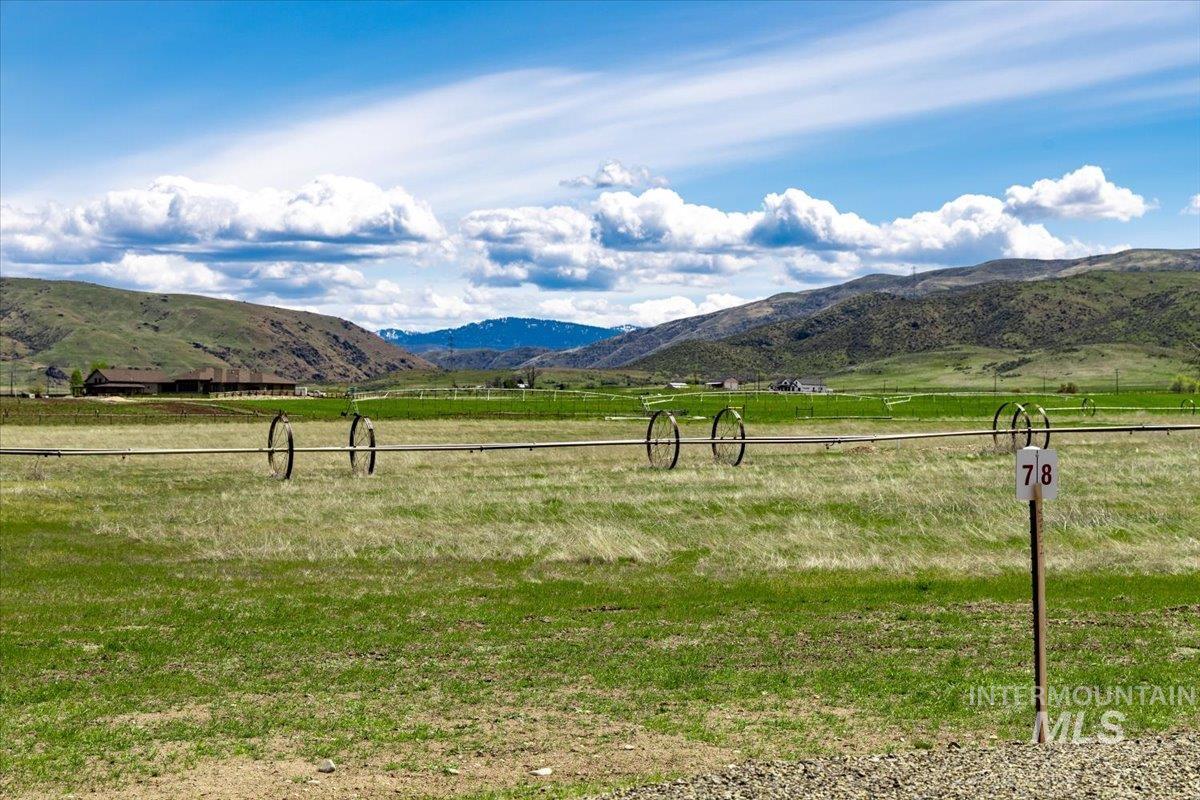 View of mountain backdrop with rural landscape