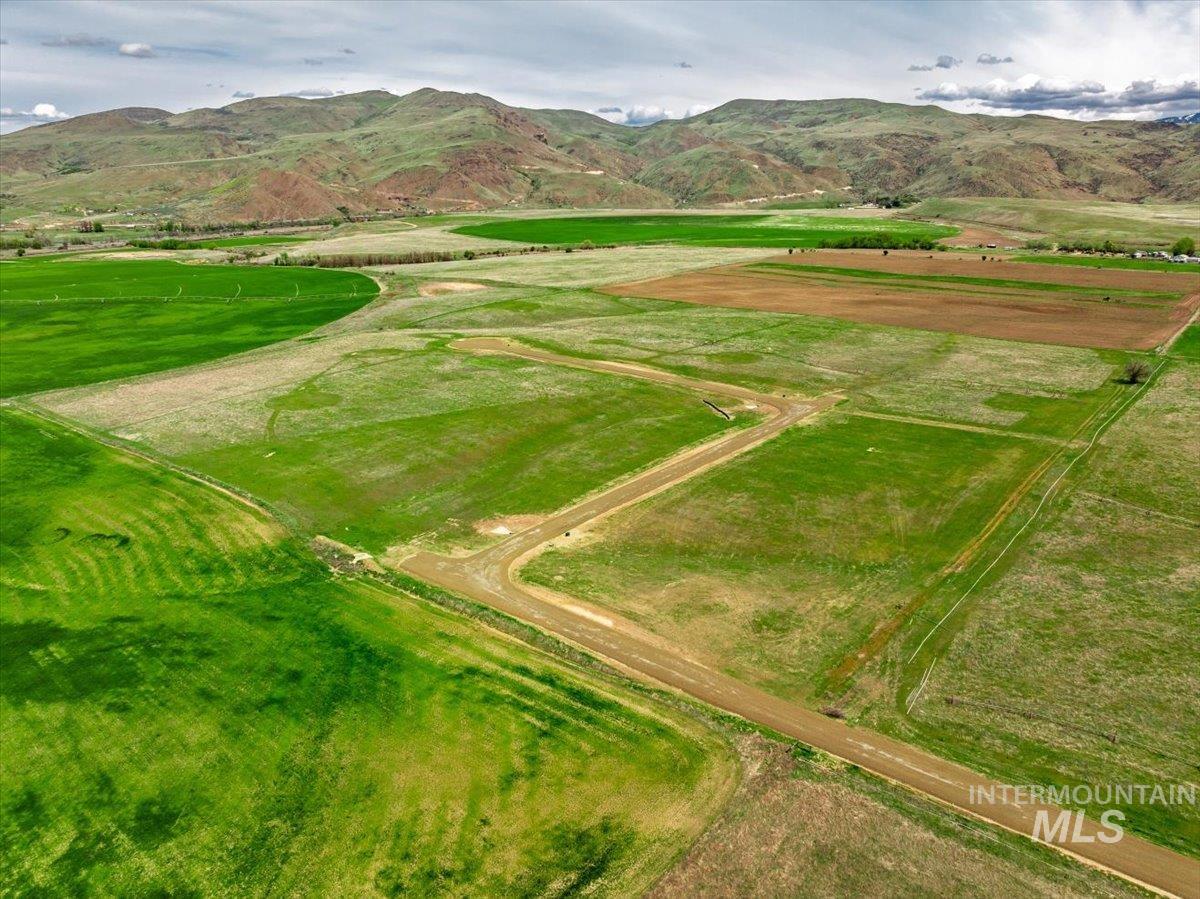 Aerial view of property's location featuring a mountainous background and rural landscape