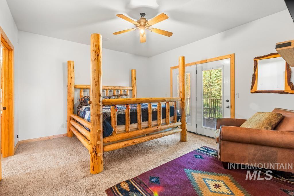 Bedroom with carpet floors, access to outside, and a ceiling fan