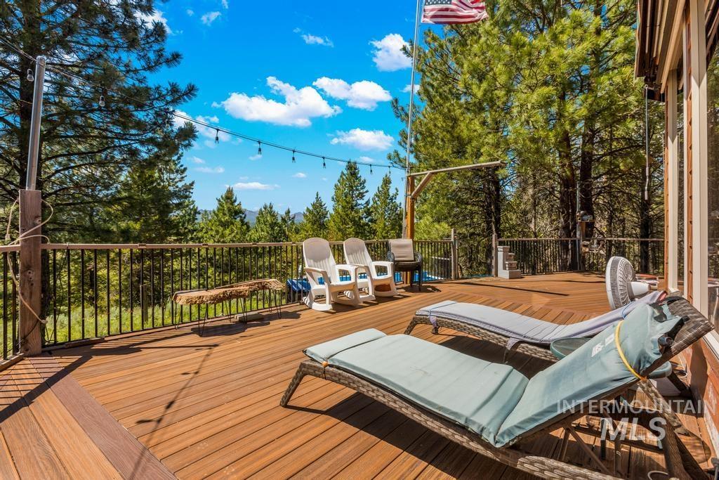 Wooden deck featuring view of wooded area