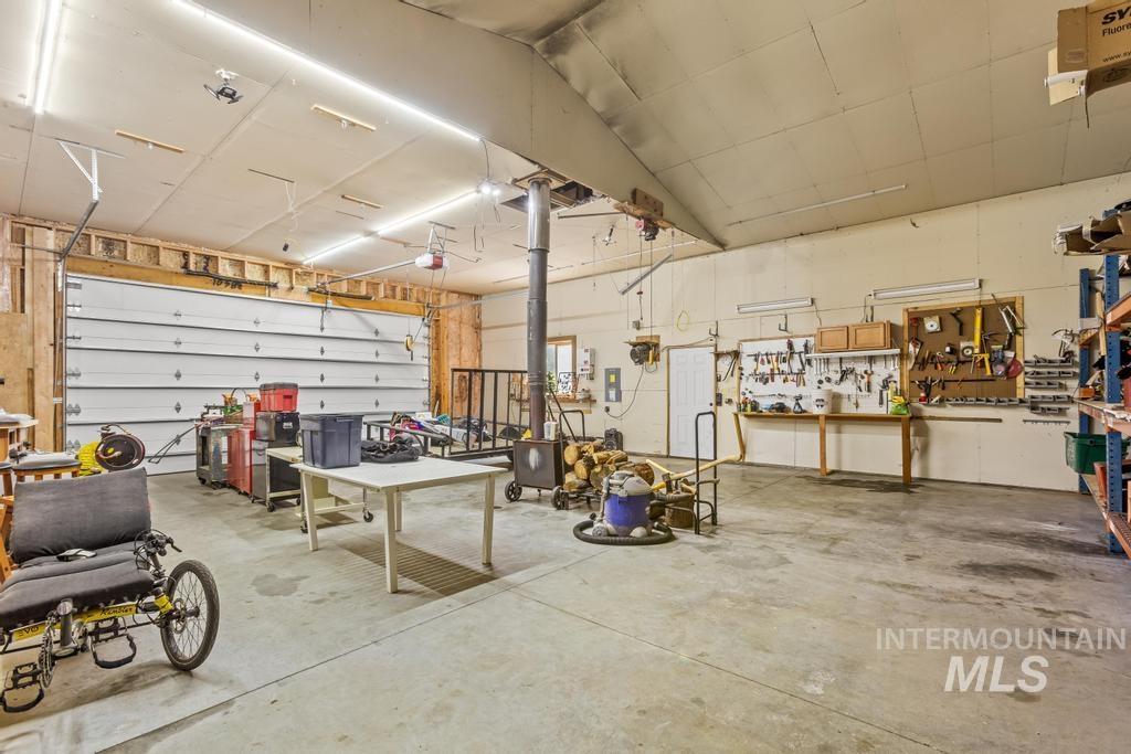 Garage featuring a workshop area and a heating unit