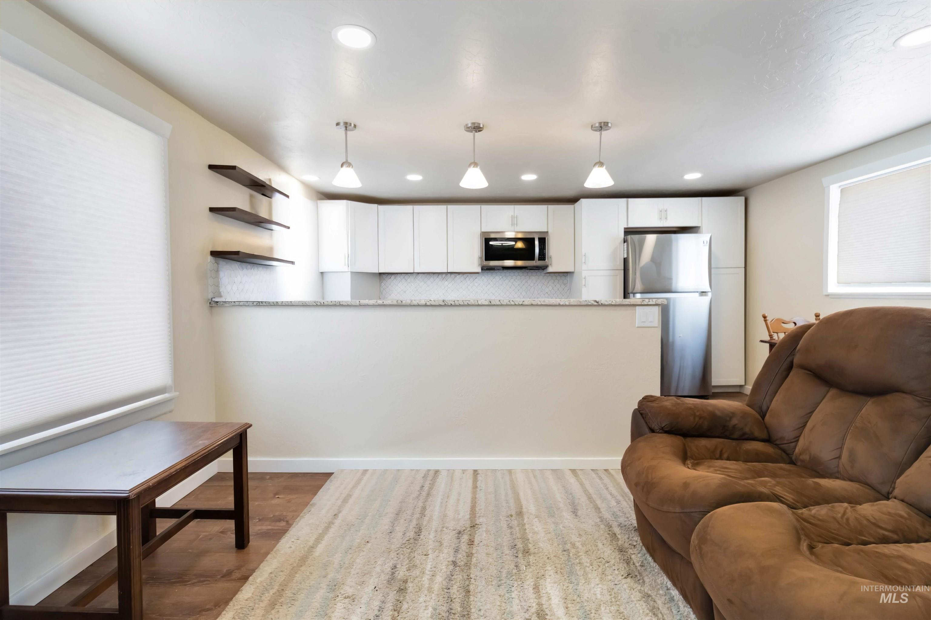 Living room featuring light wood finished floors and recessed lighting