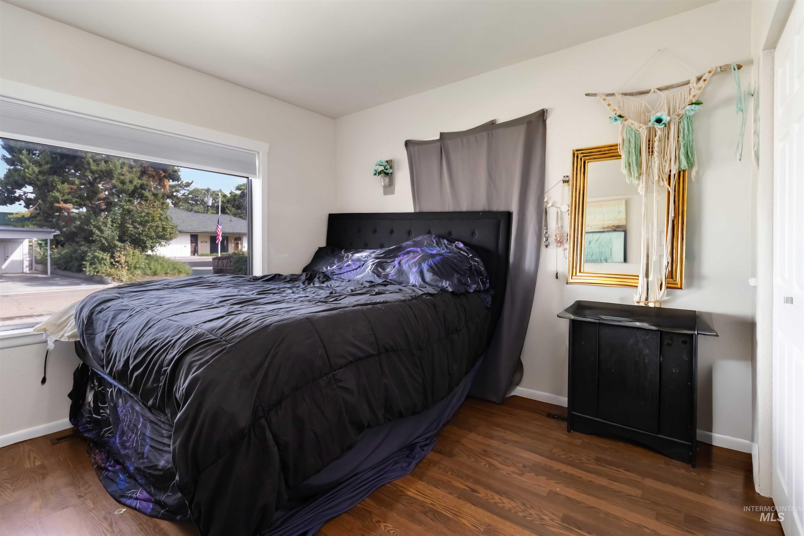 Bedroom featuring dark wood-style flooring