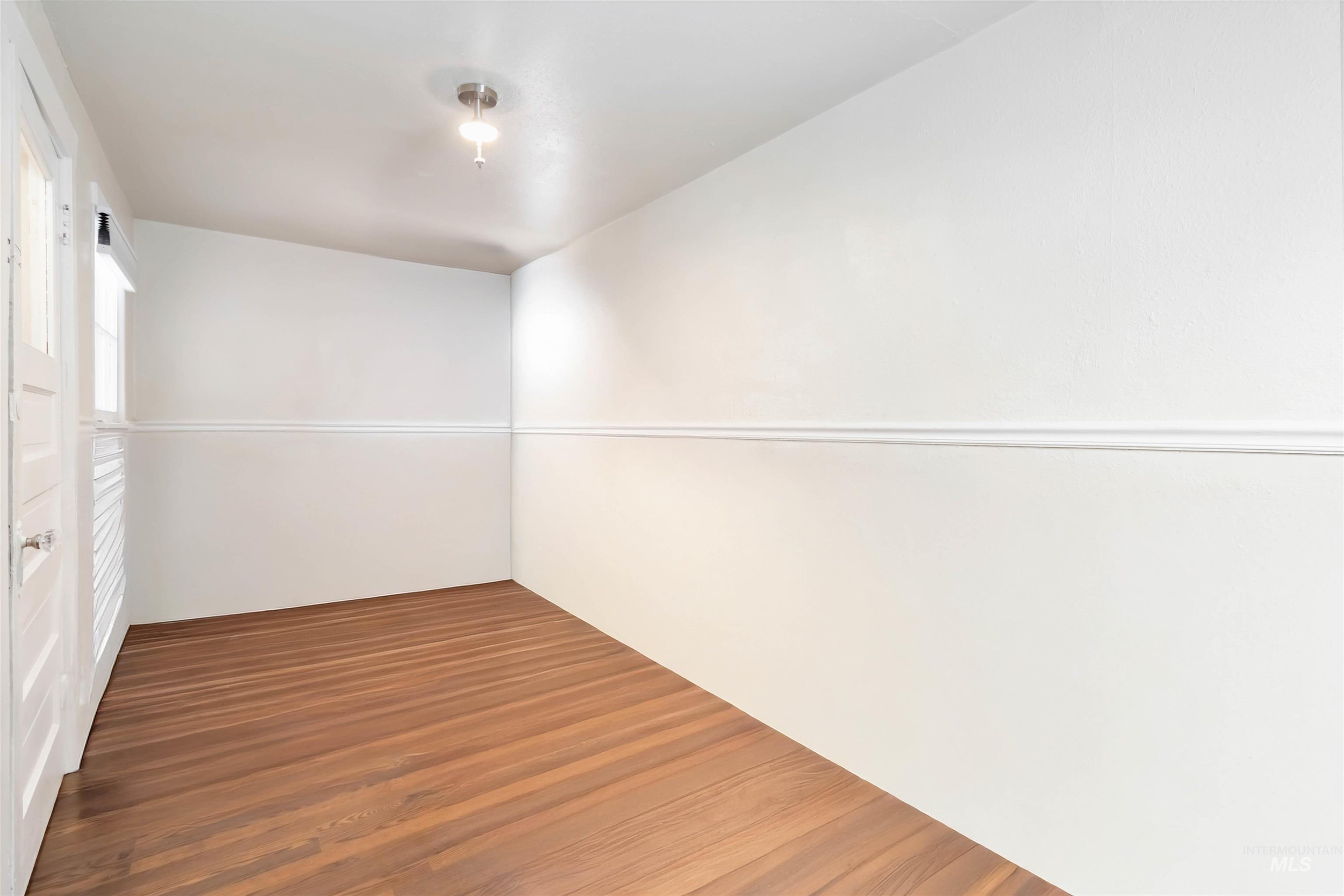 Unfurnished room with dark wood-style floors