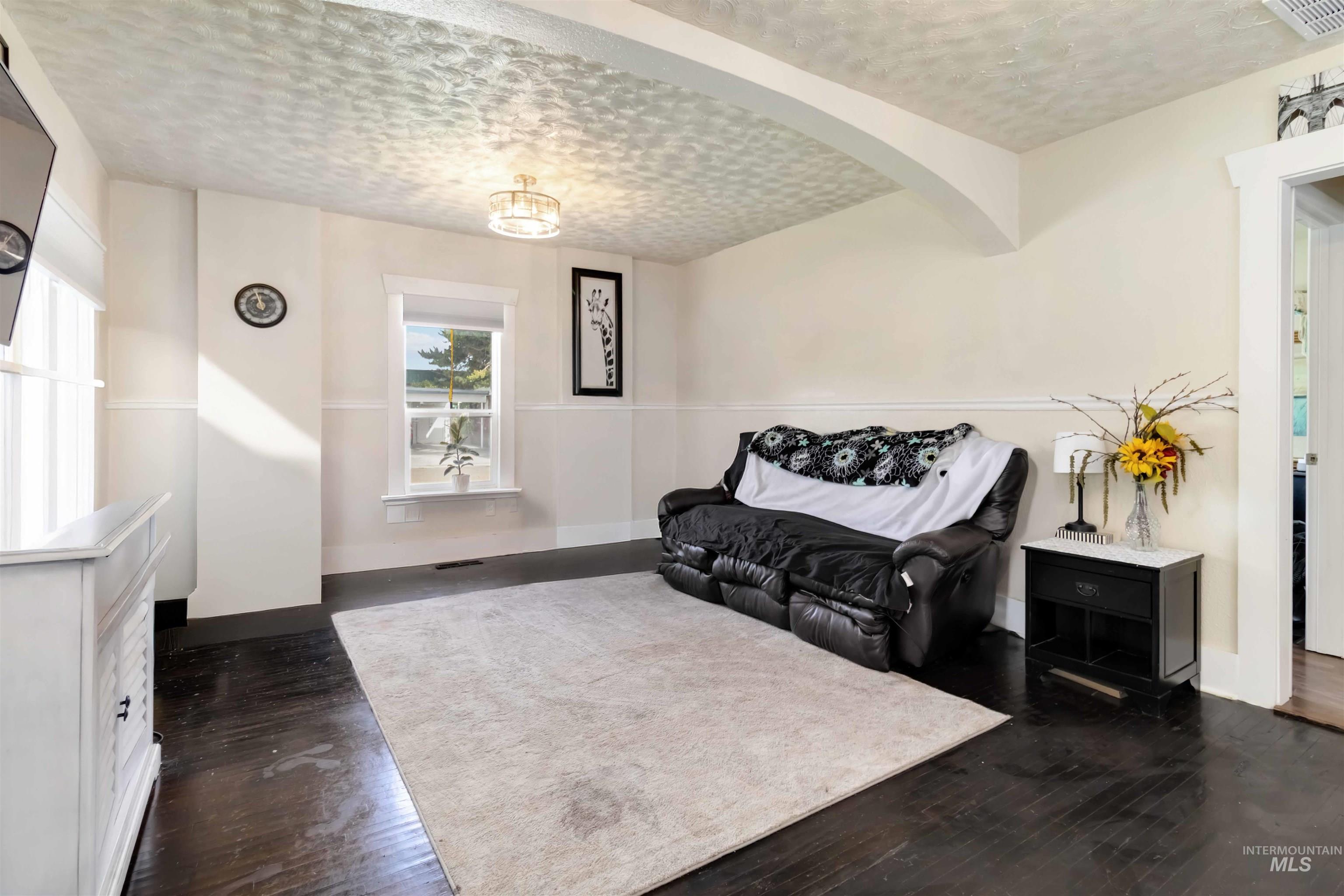 Living area with dark wood finished floors and a textured ceiling