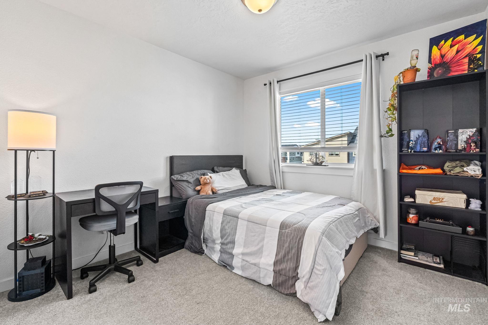 Bedroom featuring carpet and a textured ceiling