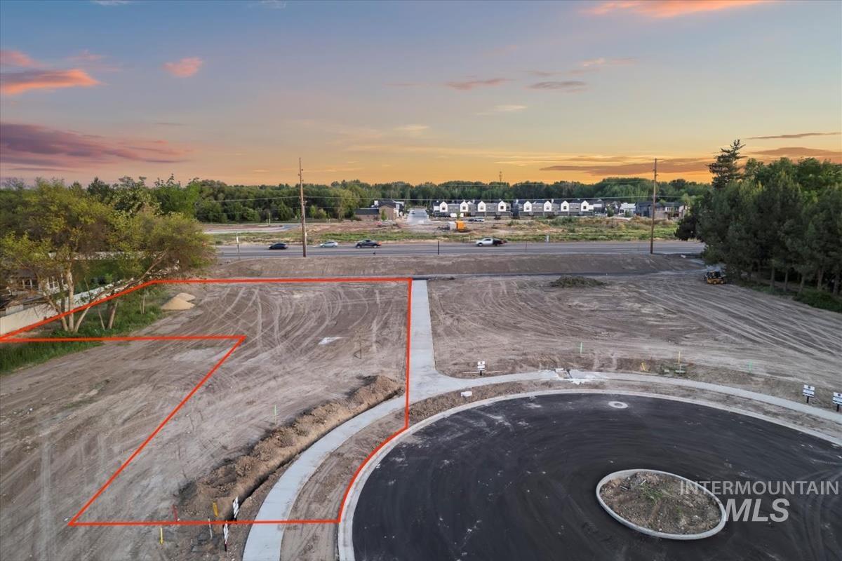 Aerial view at dusk of property parcel outlined