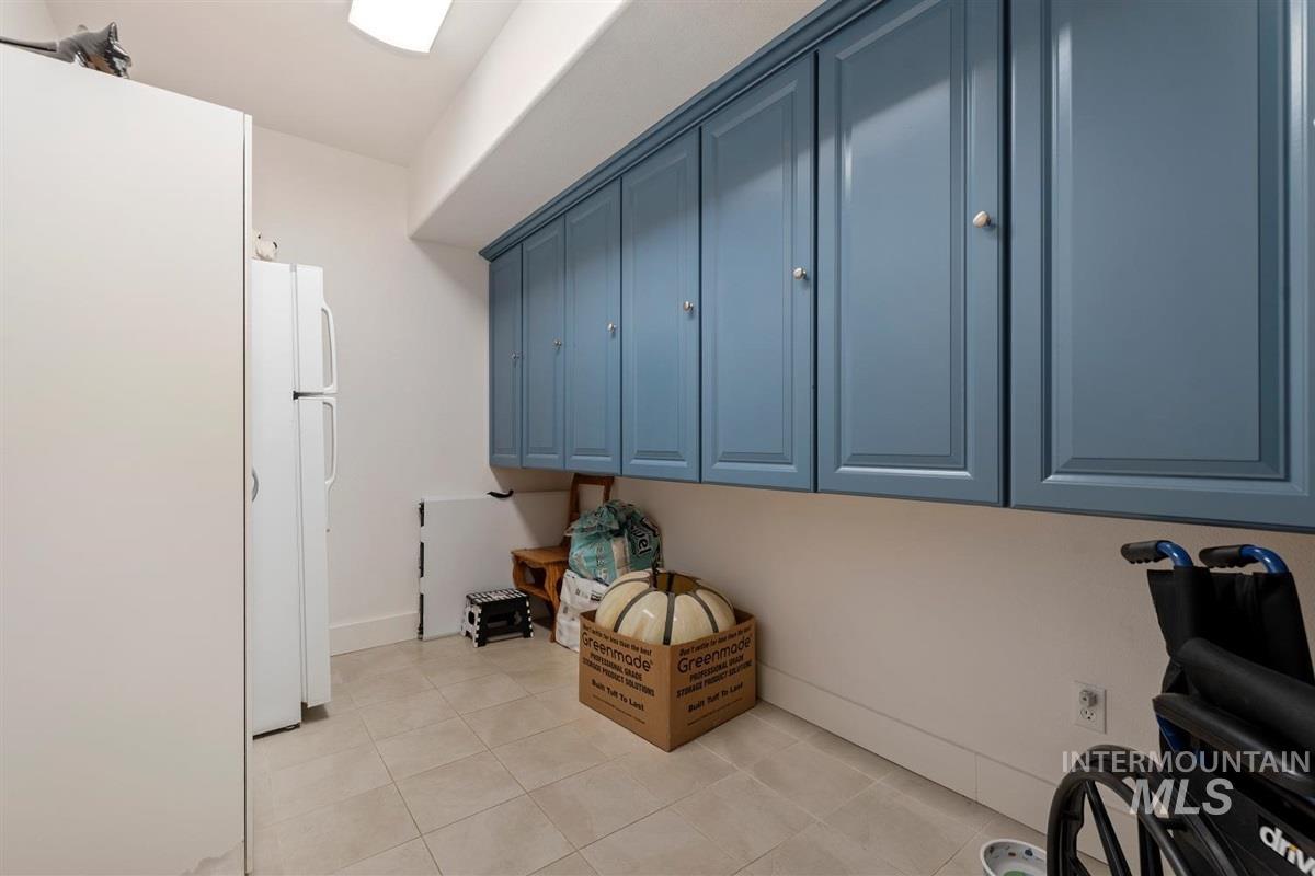 Washroom featuring light tile patterned flooring and cabinet space