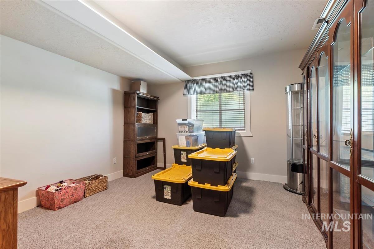 Carpeted office space with baseboards