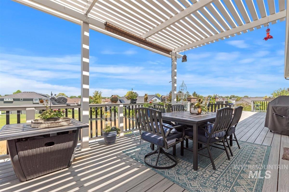 Deck featuring outdoor dining area, a pergola, a residential view, and a grill