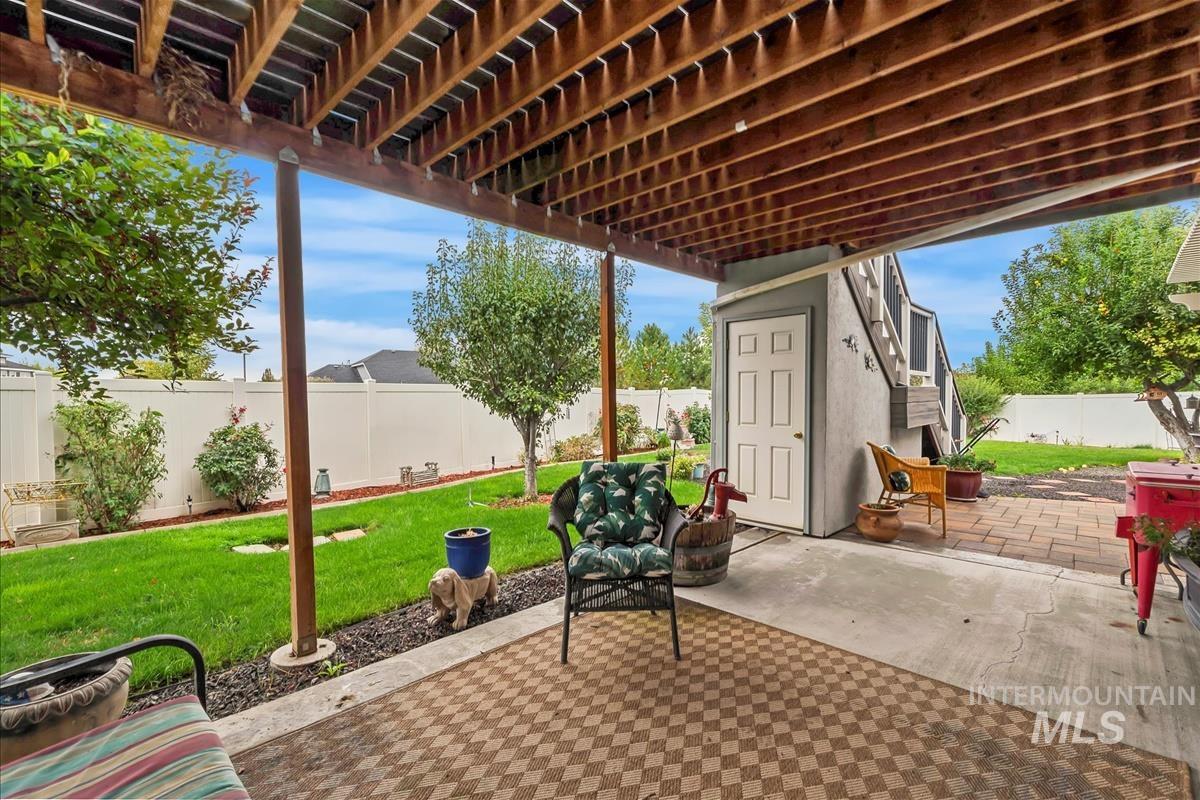 Fenced backyard featuring a patio and a pergola