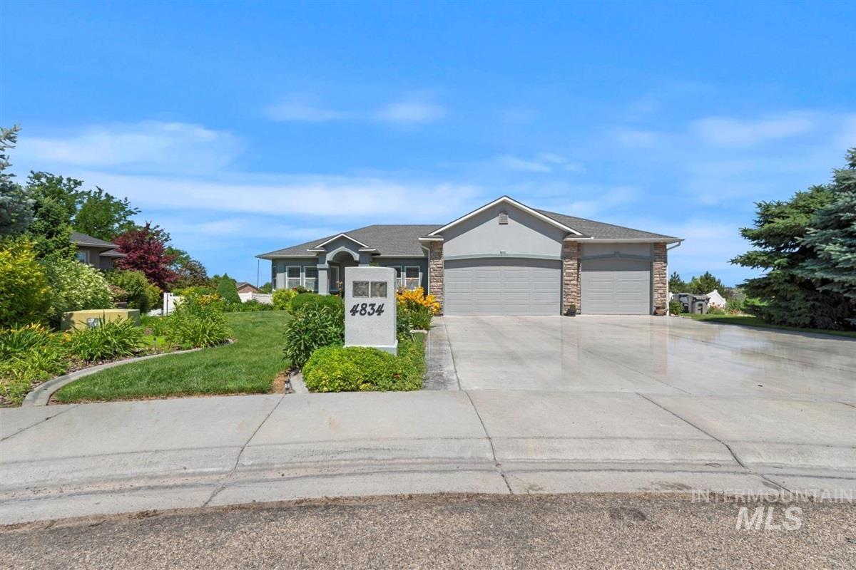 Ranch-style home with a garage, concrete driveway, and stucco siding