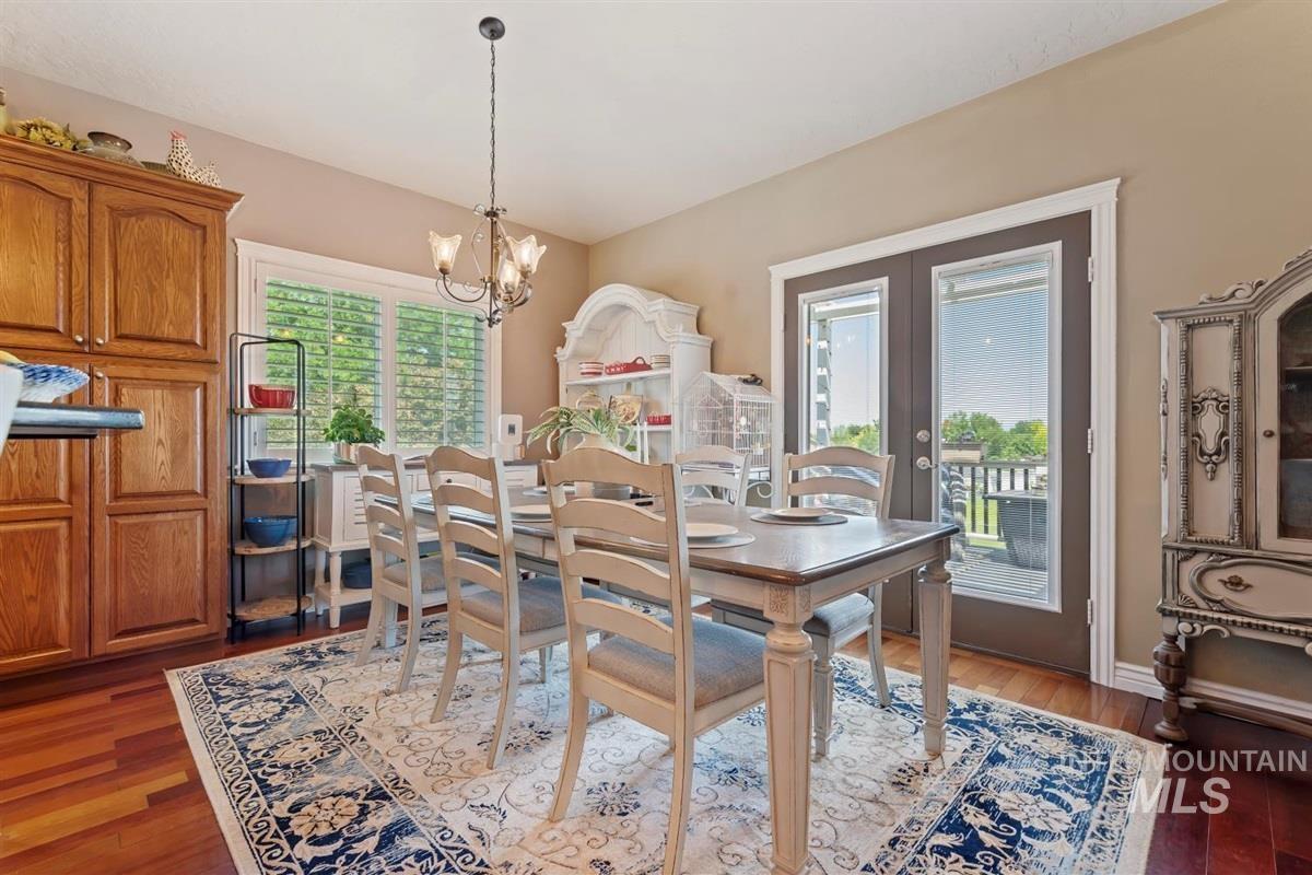 Dining space featuring a chandelier, light wood-type flooring, and french doors