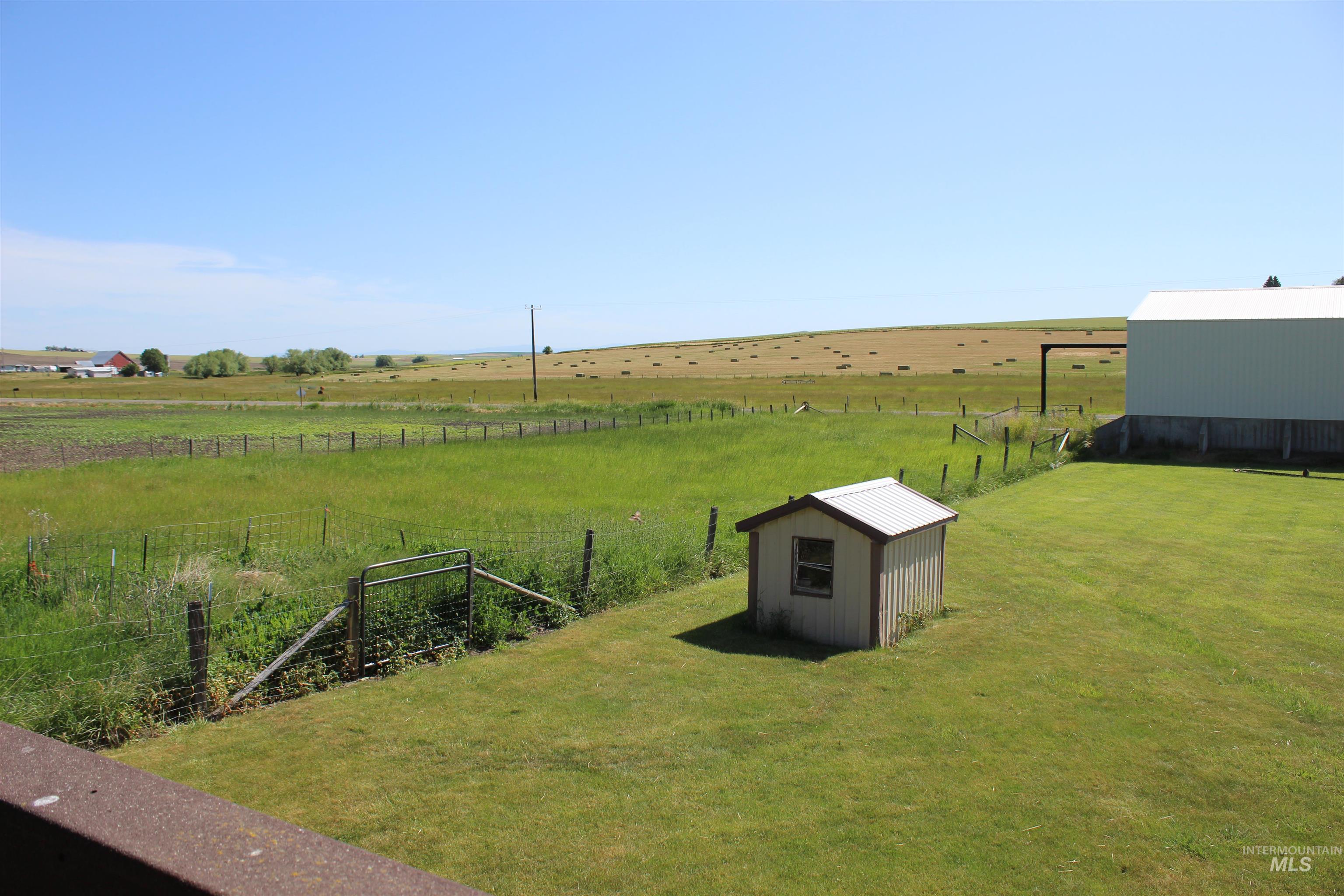 View of yard with a rural view and a storage unit