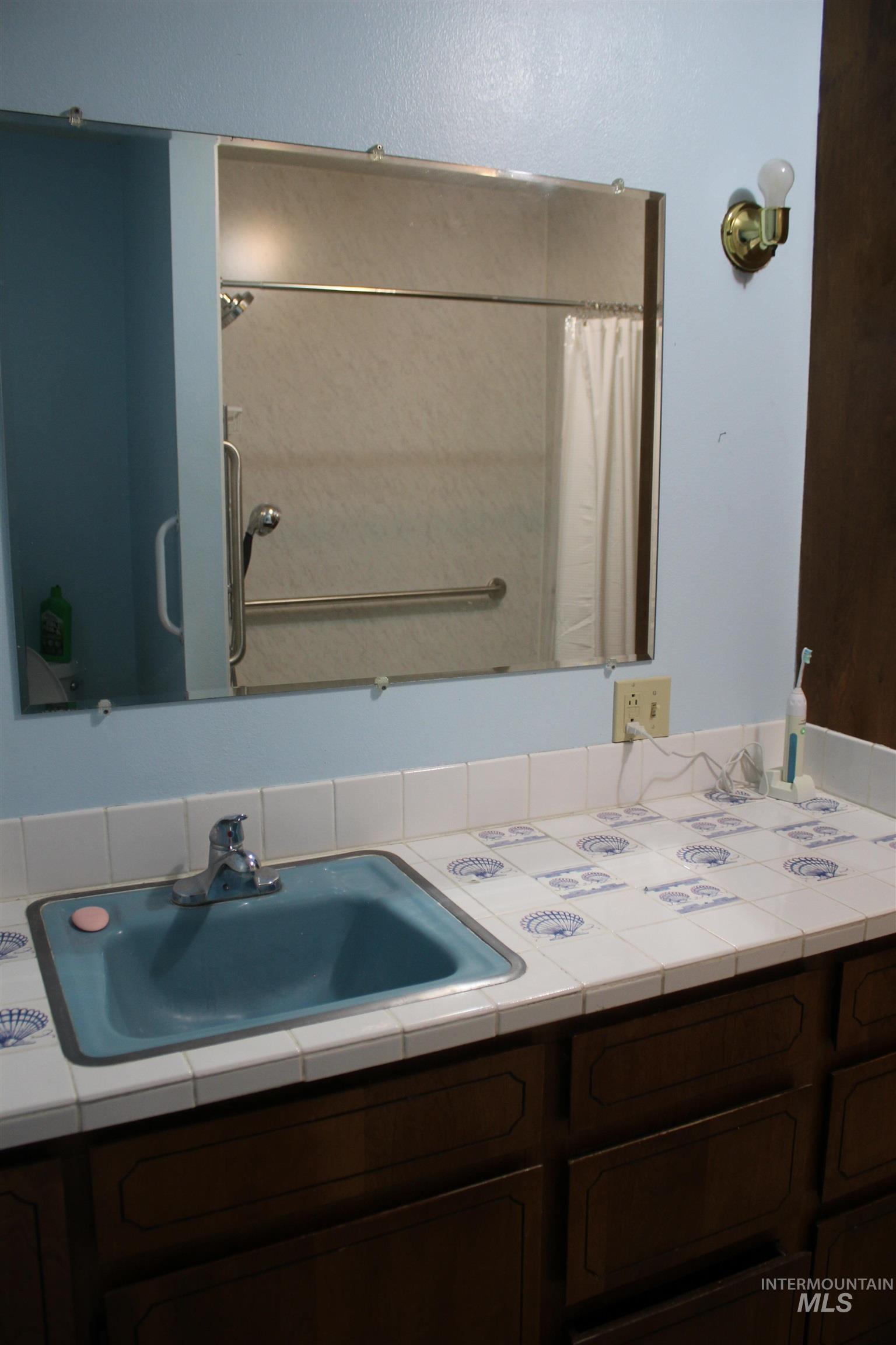 Bathroom with vanity and curtained shower
