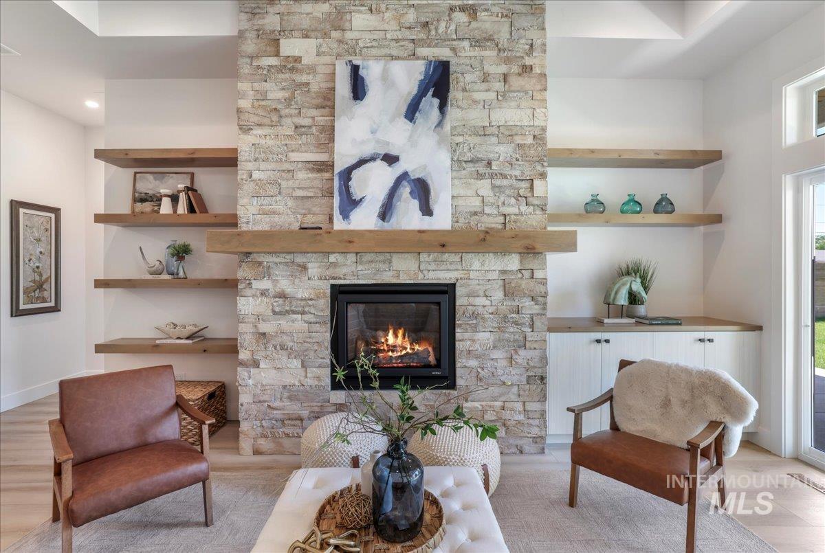 Living area with light wood-style floors and a fireplace