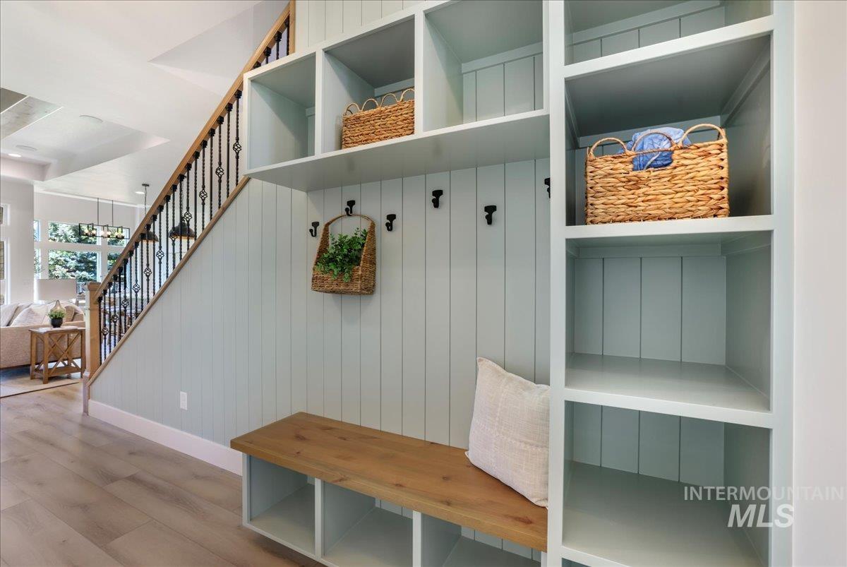 Mudroom with wood finished floors and baseboards