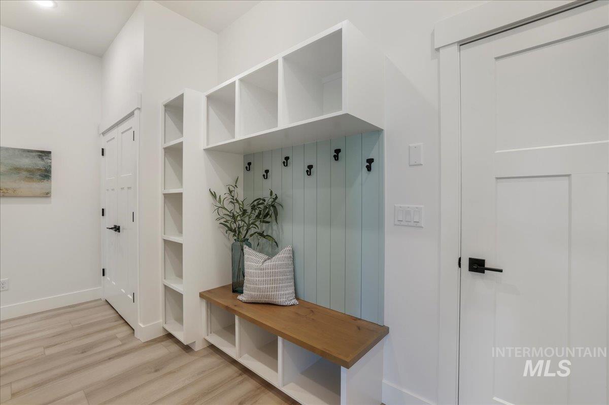 Mudroom with wood finished floors and baseboards