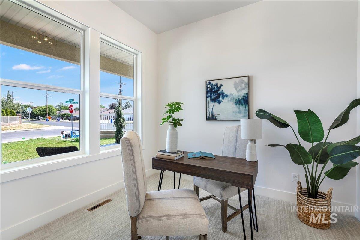 Carpeted home office with baseboards