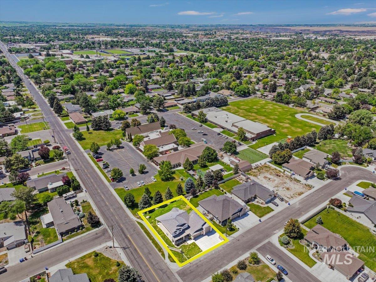 Aerial perspective of suburban area featuring property boundaries highlighted