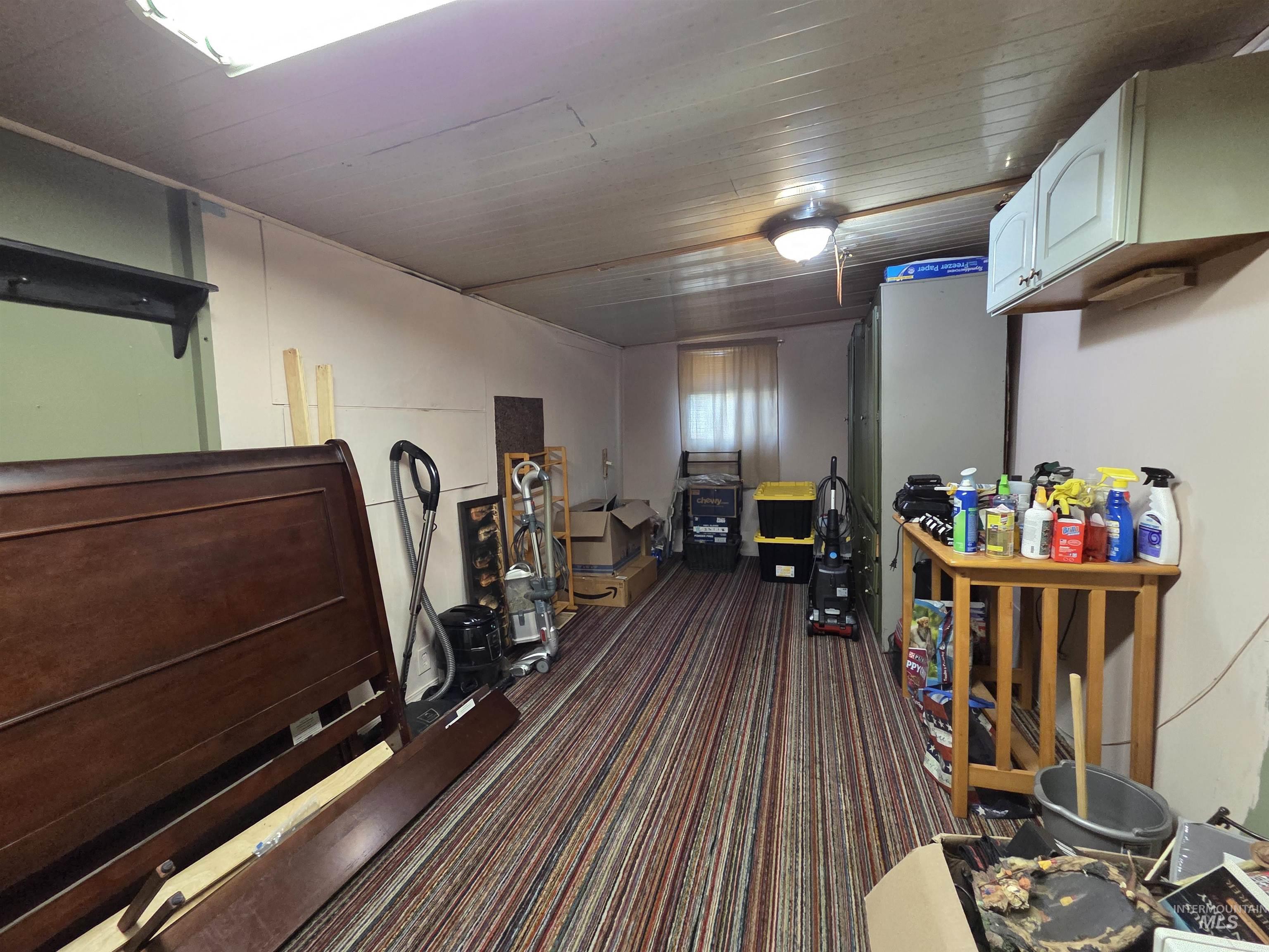 Finished below grade area featuring dark colored carpet