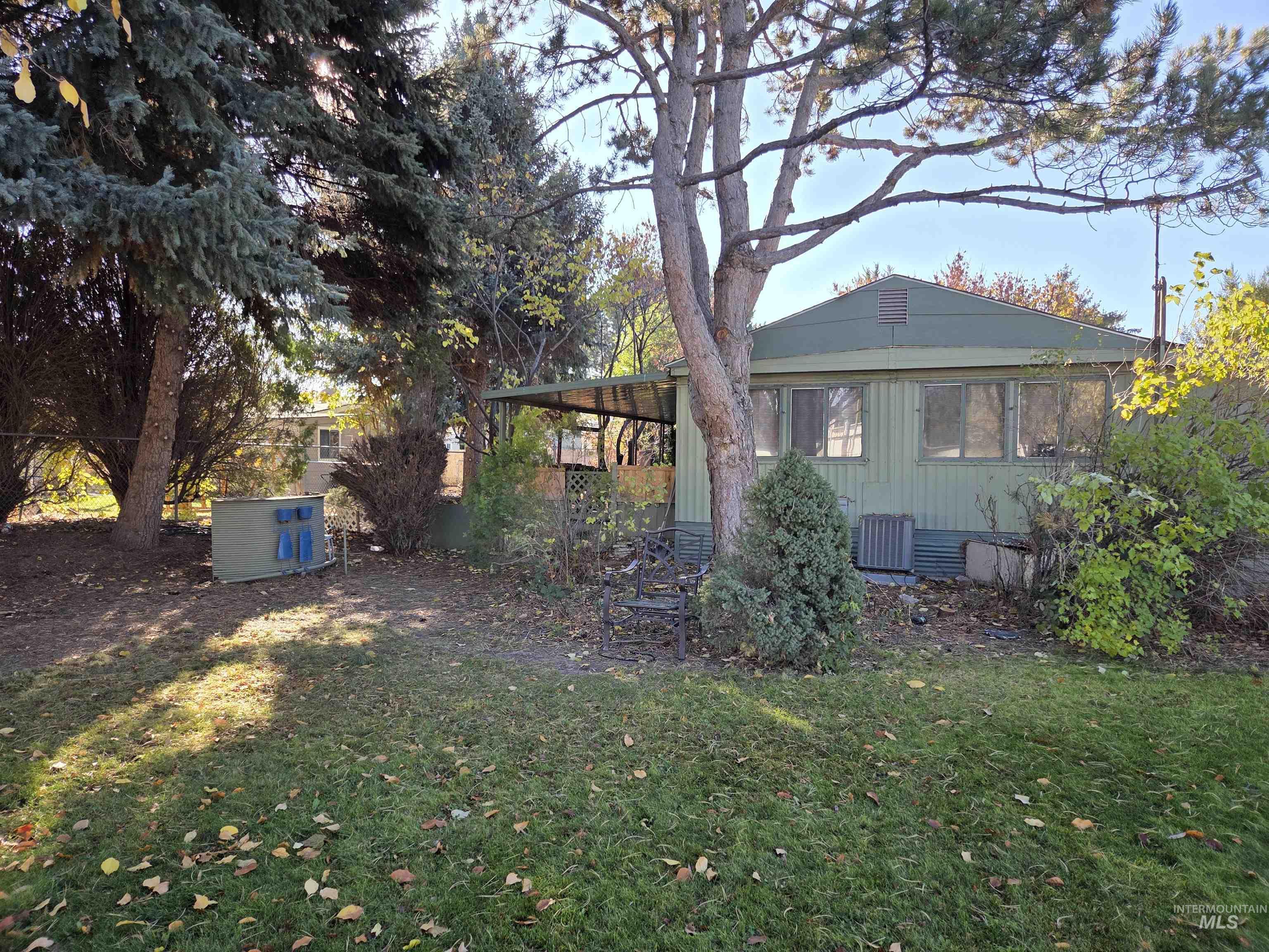 View of side of property featuring a yard and a cooling unit