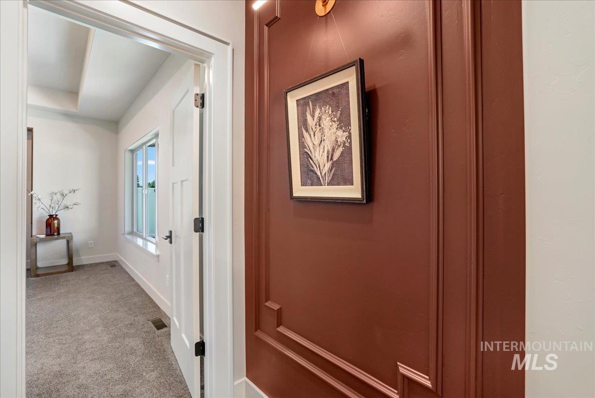 Hallway featuring carpet flooring and baseboards