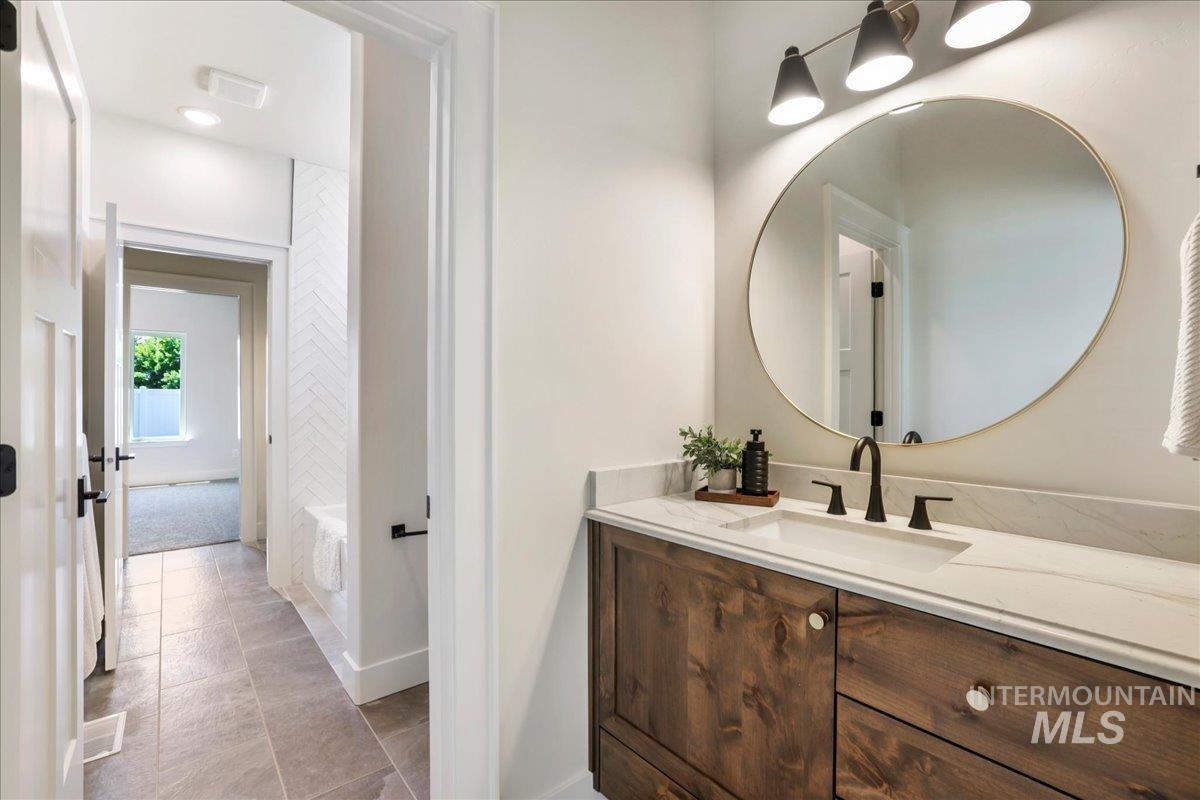 Full bath featuring vanity and a bathtub