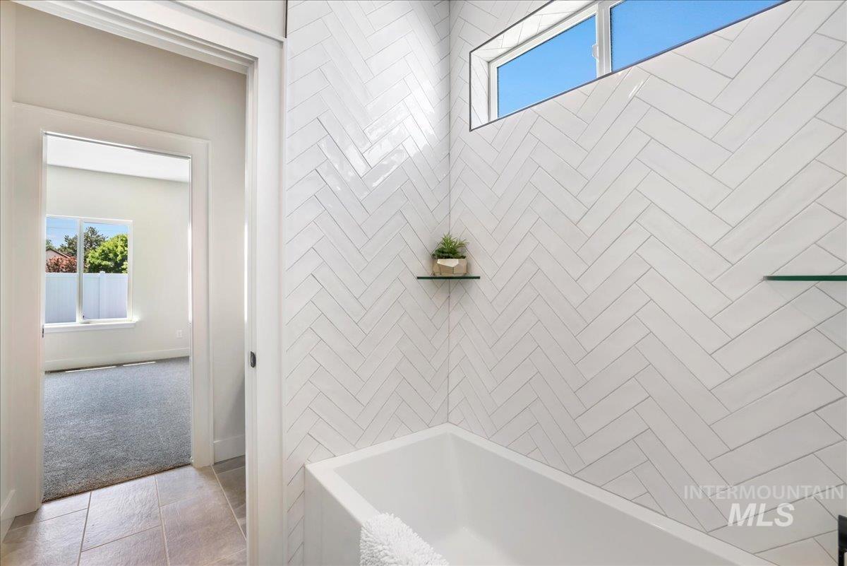 Bathroom with plenty of natural light and shower / washtub combination