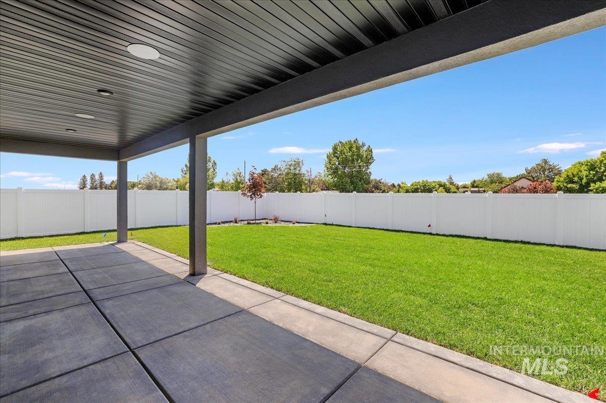 Fenced backyard with a patio area