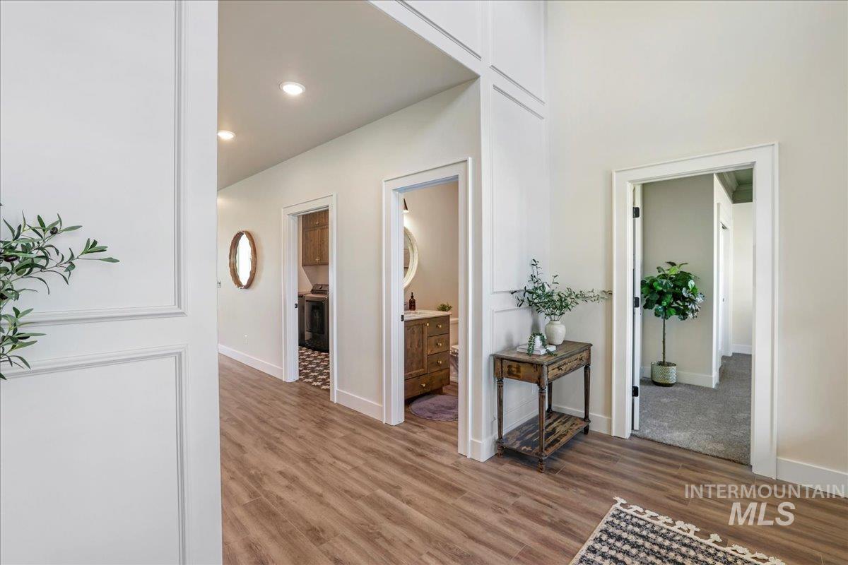Hall featuring light wood-type flooring and recessed lighting