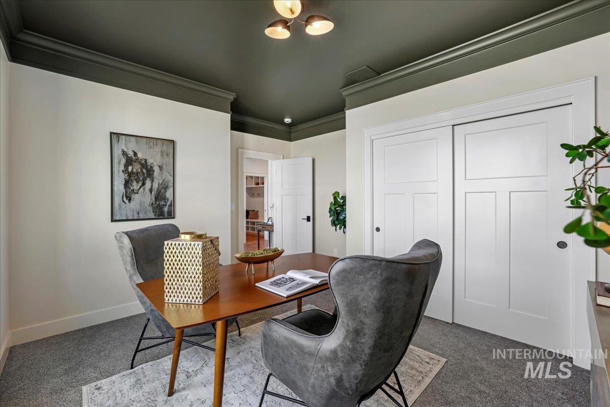 Carpeted office featuring ornamental molding and baseboards