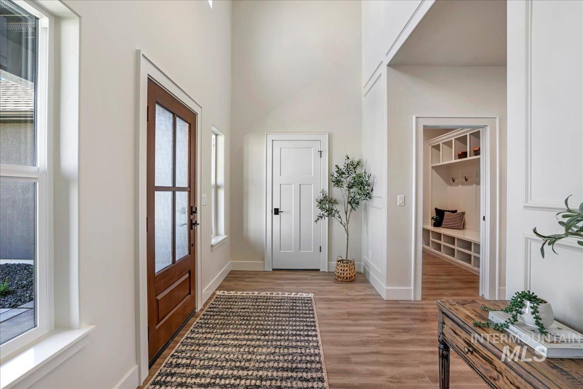 Foyer featuring light wood-style floors and a high ceiling