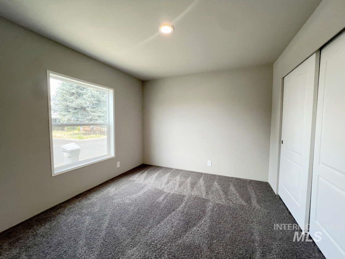 Unfurnished bedroom with carpet, a closet, and recessed lighting