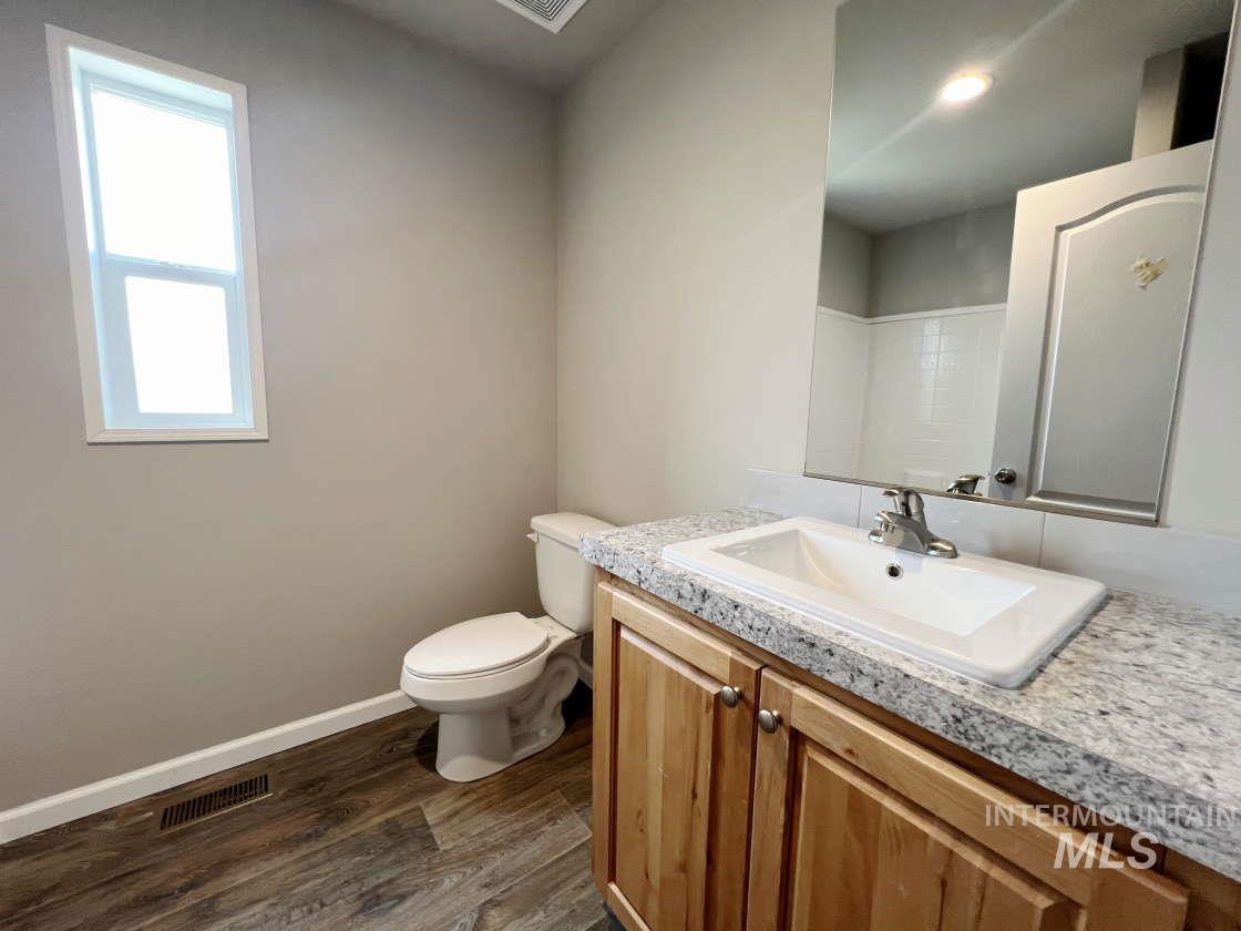 Bathroom with wood finished floors and vanity