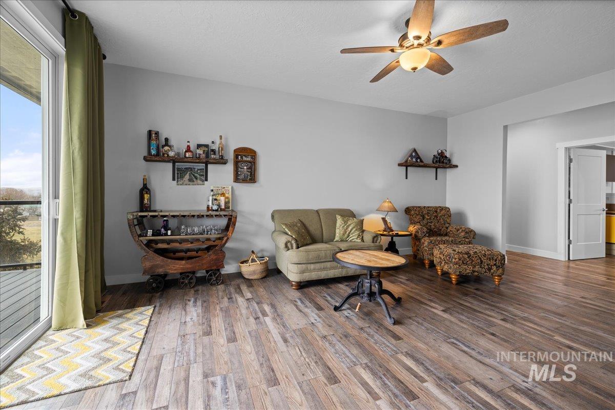 Family room featuring wood finished floors and a ceiling fan