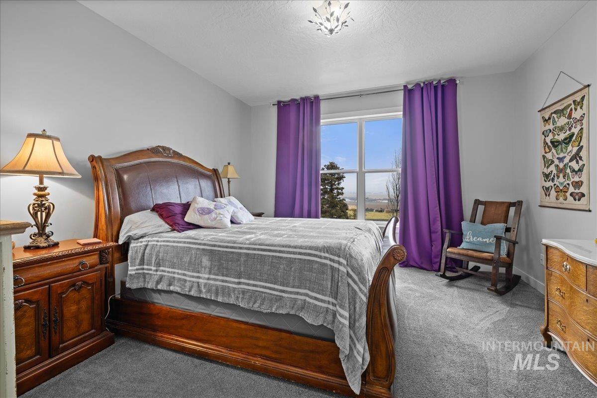 Bedroom with carpet floors and a textured ceiling
