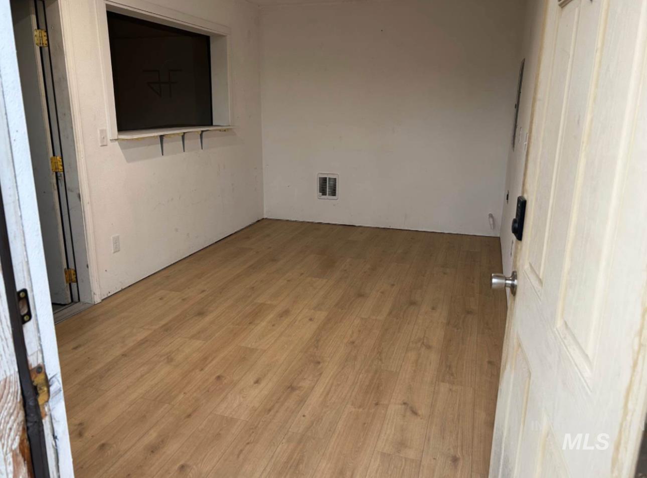 Empty room featuring light wood finished floors