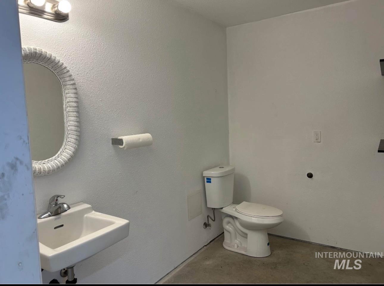 Bathroom with a sink and concrete floors